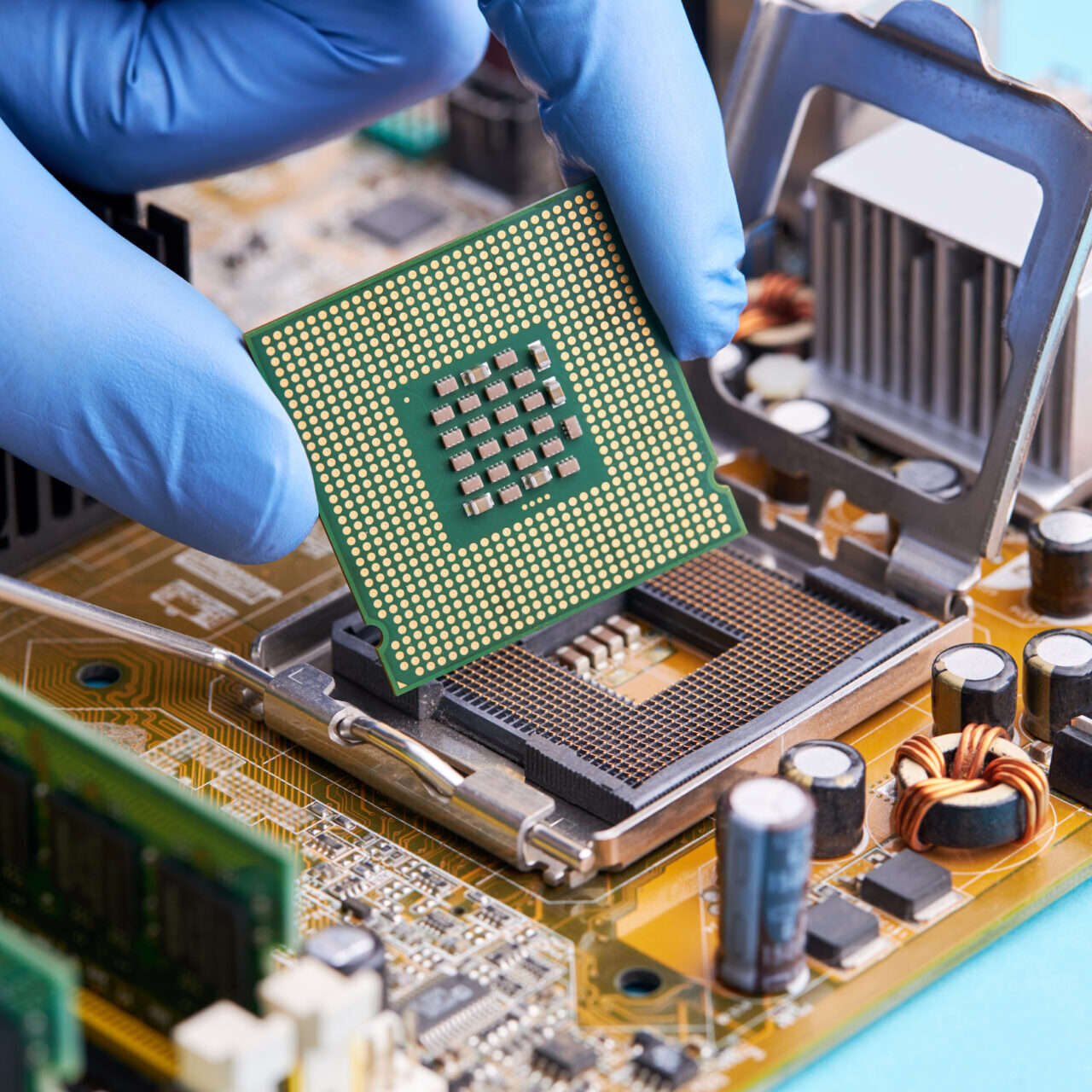computer hardware service concept. technician repairing desktop pc or laptop circuit board. person install cpu chip to pcb socket.; Shutterstock ID 1819204742; purchase_order: -; job: -; client: -; other: -