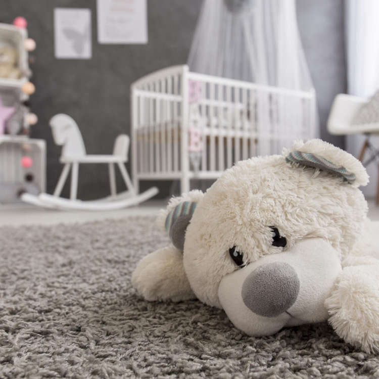 Shot of a teddy bear laying on a carpet in a cozy baby girl room; Shutterstock ID 432771475; Purchase Order: -